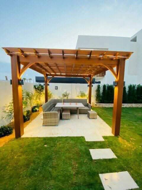 Timber pergola with lounge seating on a lawn
