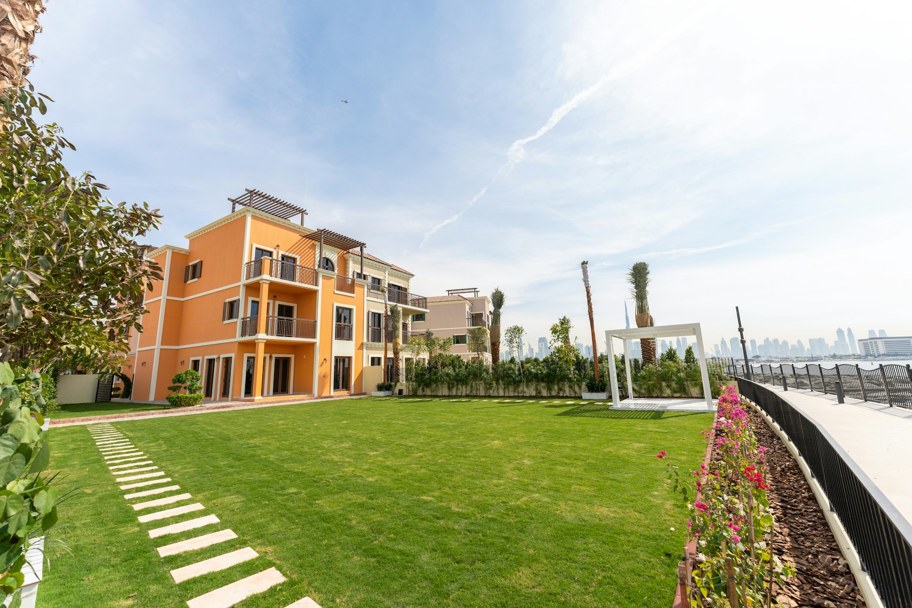Lawn with stepping stones and flowering border in Dubai